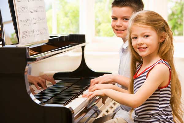 Kids practicing piano